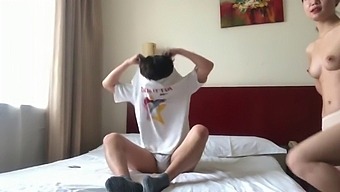 A Pair Of Chinese Lovers Share A Private Moment In A Hotel Suite